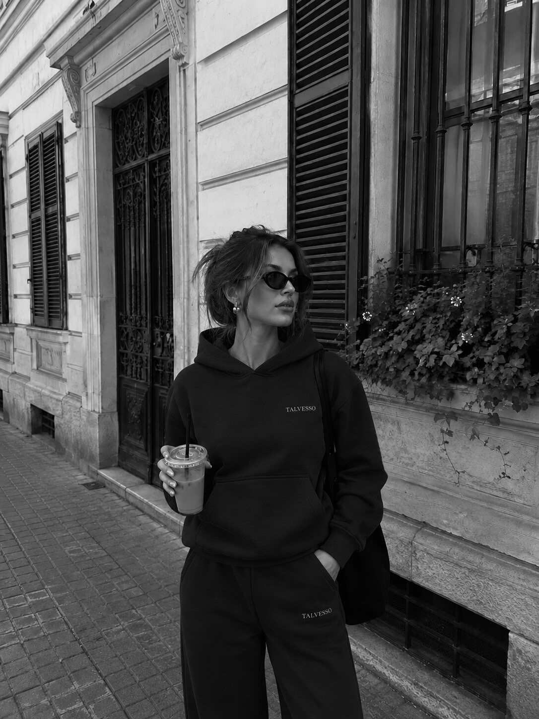 Female model in the navy TALVESSO tracksuit on a city street